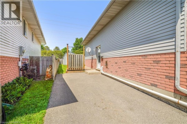 Living room with a sofa, chairs, coffee table, and wooden furniture. - 58 Arbor Drive, Brantford