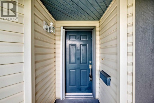 Close-up of a dark blue front door with a mailbox on the right side. - 58 Chaparral Terrace Se, Calgary