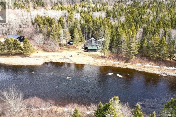 Aerial view of a green cabin and a small outbuilding on a bank beside a slow-moving river. - 58 Dufour Road, Piskahegan
