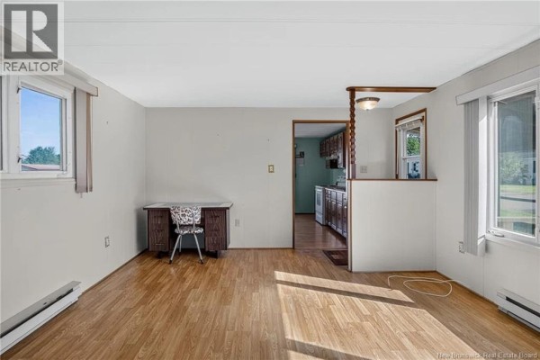 View of a living area with a desk, chair, and a doorway leading to the kitchen. - 58 Second Street, Sussex Corner