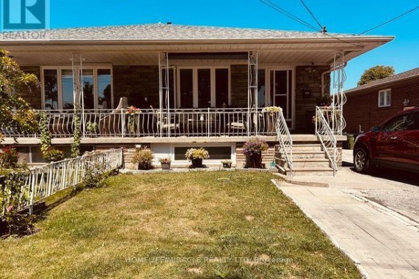 Close-up of the front porch of a brick house with white railings. - 58 Telco Crescent, Toronto