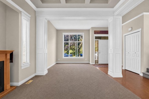 Spacious foyer with a staircase, wood flooring, and beige walls. - 5818 167a Street, Surrey