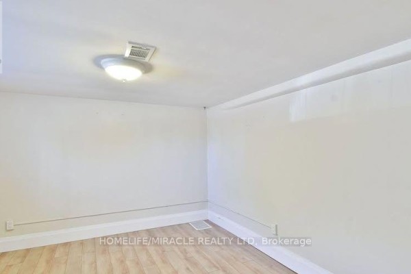 Empty room with light wood flooring, white walls, and white trim. - 584 Montgomery Street, Oshawa