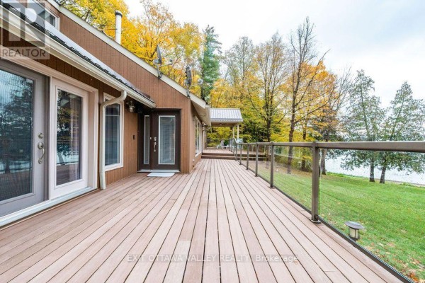 Aerial view of the home near a body of water, with lush greenery around. - 585b Two Mile Trail, Whitewater Region