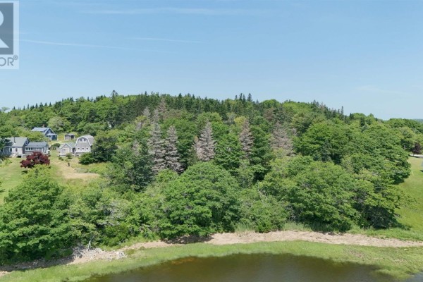 Aerial view of houses on a wooded hillside overlooking a calm body of water. - 5881 Highway 3, Glenwood