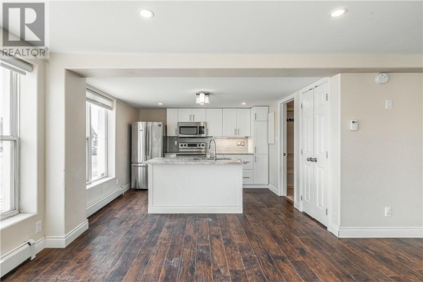 Another angle of the kitchen showcasing modern appliances and ample storage space. - 59-61 Lorne Street, Sudbury