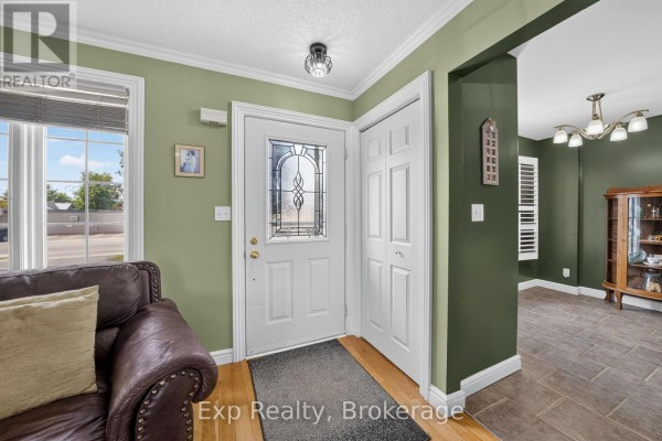 Entranceway featuring a white door with a decorative glass panel and closet. - 59 Avondale Road, Belleville