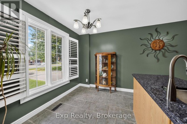 Dining area with tiled floors, plantation shutters, glass display cabinet, and granite countertop. - 59 Avondale Road, Belleville