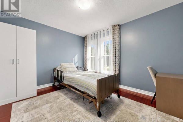 Bedroom with hospital bed, wardrobe, and desk - 59 Brennan Road Ajax