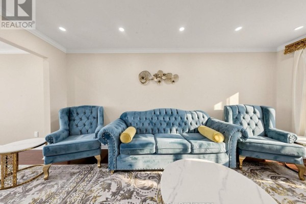 Close-up of teal velvet sofas and armchairs in a living room with a marble coffee table. - 59 Brennan Road, Ajax