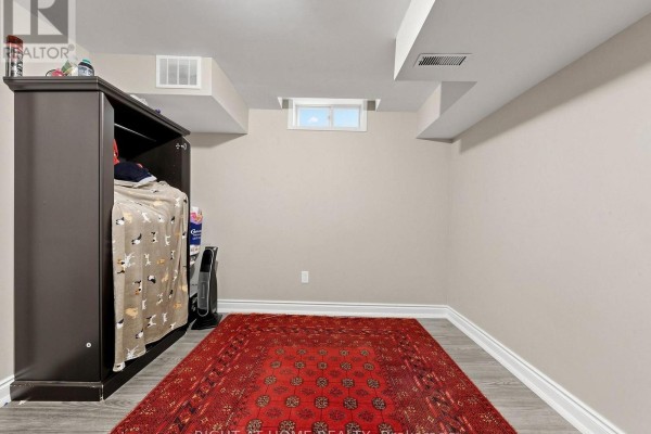 Basement room with wardrobe, oriental rug, and small window - 59 Brennan Road Ajax