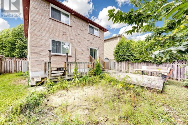 Backyard with wooden deck and seating - 59 Brennan Road Ajax