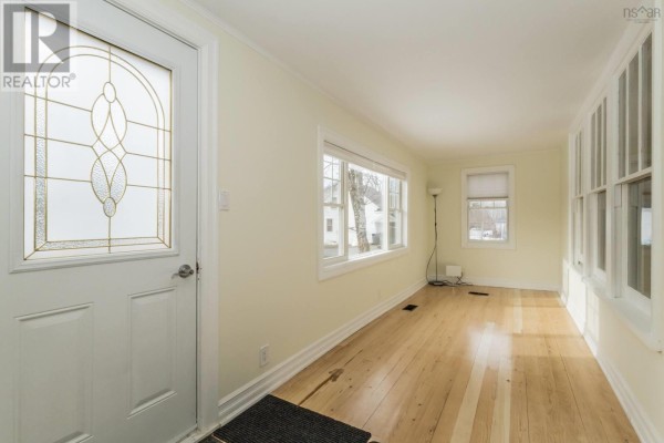 Spacious living room featuring a brick fireplace and built-in shelves - 59 Highway 201, Lequille