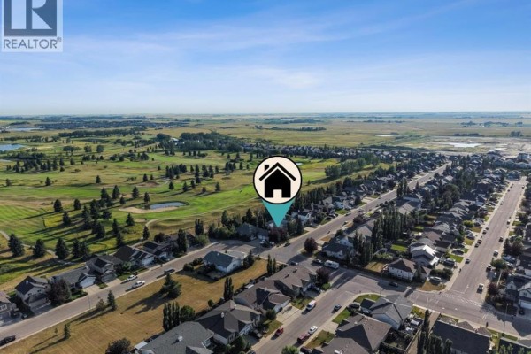 Aerial view of a residential street next to a golf course with flat, open landscape in the distance. - 59 Hillview Road, Strathmore