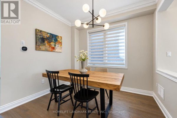 Dining area with a wooden table and chairs, showcasing a modern chandelier and window blinds. - 59 Hilts Drive, Richmond Hill
