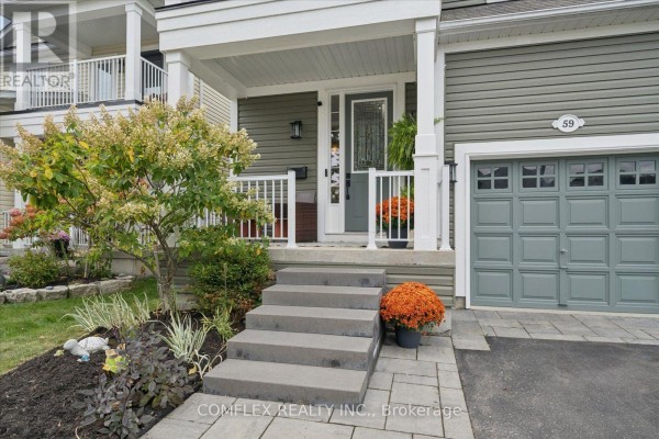 Close-up of the grey front door, garage door, and stone steps of a house. - 59 Hodnett Crescent, Clarington