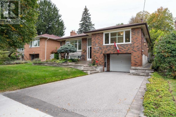 Driveway and front view of the brick home with a garage and landscaped entrance. - 59 Landfair Crescent, Toronto