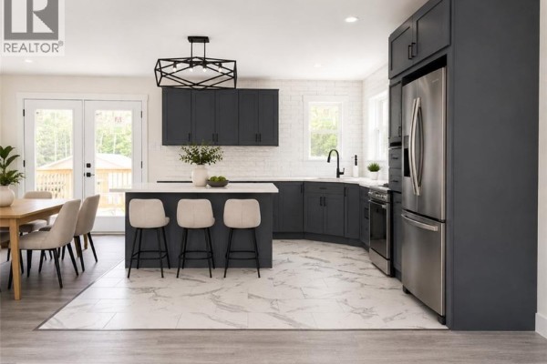 Open-concept kitchen with dark grey cabinets, white countertops, and a large island. - 59 Malibu Street, Marysville