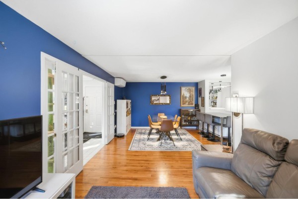 View from living room looking into dining area with blue walls and glass doors. - 59 Rue Des Carouges, #3, Gatineau