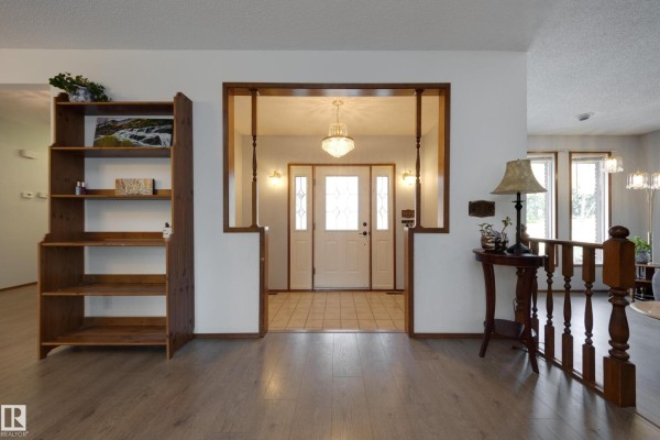 Interior view from hallway looking towards the front door and staircase. - 59 Spruce Av, Sherwood Park