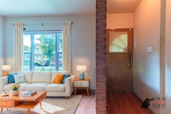 Living room with a white sofa, coffee table, and a view of the entryway. - 591 Home Street, Winnipeg