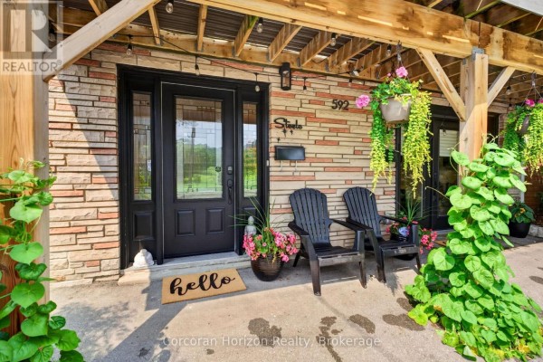Close-up of the entrance to the lower level, featuring stone facade and double doors. - 592 Aberdeen Avenue, Hamilton