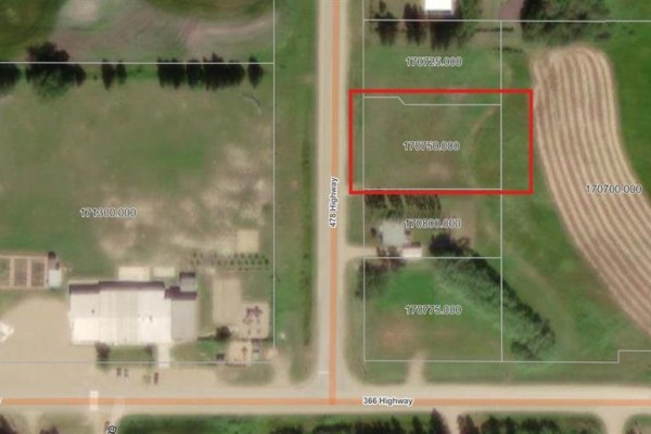 Aerial view highlighting Lot 170750.000 with a red border, adjacent to a tree line and field. - 592 Route-1 Road, Inglis