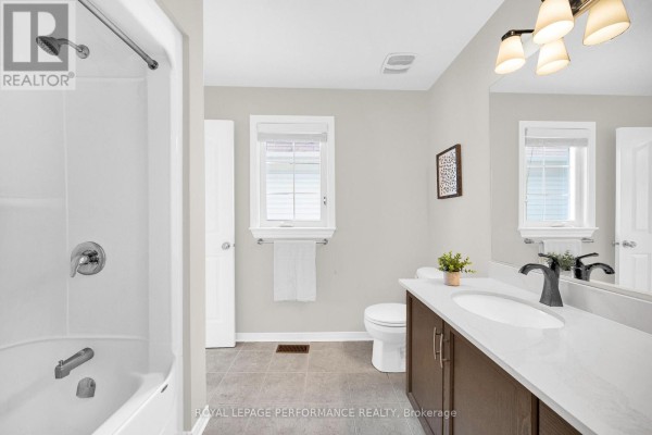 Modern bathroom vanity, sink, and toilet with shower and tub - 593 Pinawa Circle Ottawa