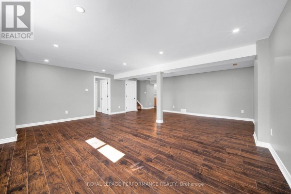 Modern finished basement with hardwood floors and recessed lighting - 593 Pinawa Circle Ottawa
