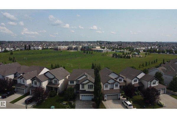 Aerial view of a residential neighborhood with houses, a park, and a school. - 5931 12 Av Sw, Edmonton