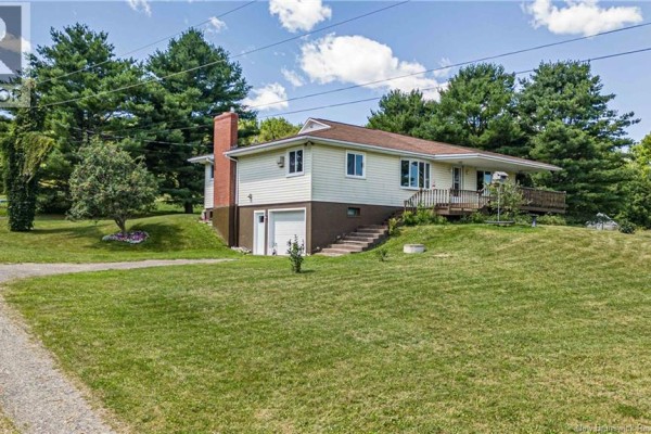 Living room with a large sectional sofa, wood-paneled walls, and a large window. - 596 165 Route, Riceville