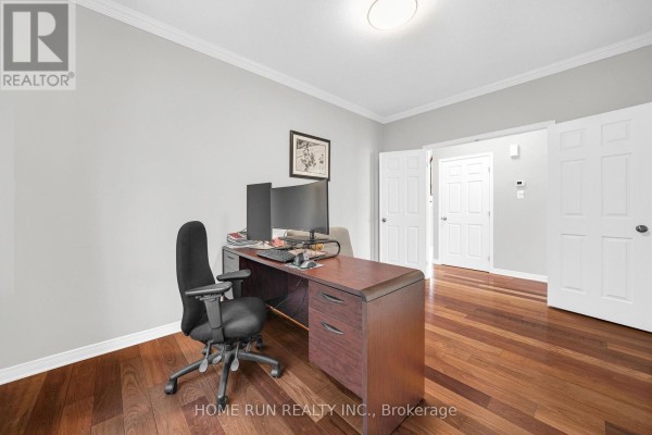 Office with dual monitors on a wood desk and hardwood floors - 596 Anjana Circle Ottawa