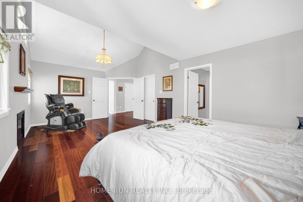 Bedroom with massage chair, vaulted ceiling, and hardwood floors - 596 Anjana Circle Ottawa