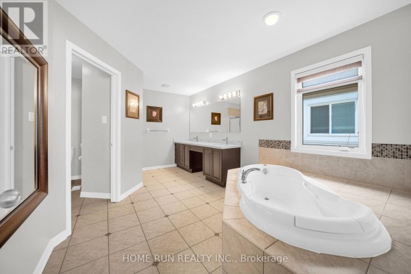 Soaking tub and double vanity in a spacious bathroom - 596 Anjana Circle Ottawa