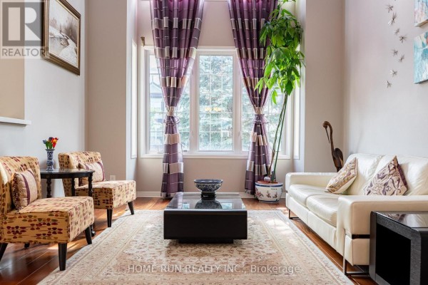 Living room with white leather sofa, accent chairs, large window, and rug - 596 Anjana Circle Ottawa