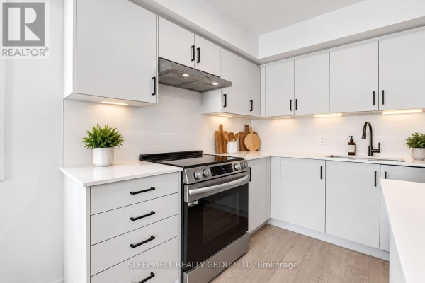Close-up of a modern kitchen with white subway tile backsplash, black hardware, stainless steel stove, and under-cabinet lighting. - 6 - 152 Springhurst Avenue, Ottawa