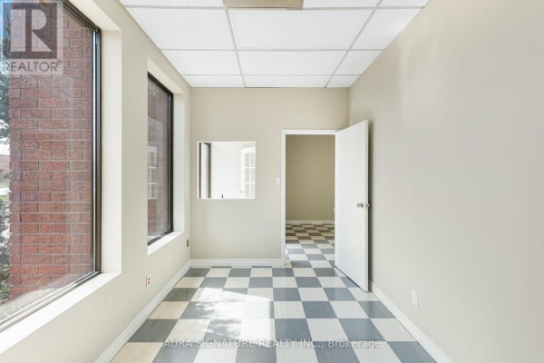 Break room featuring kitchenette, checkered flooring, and water dispensers - 6 - 176 Rivermede Road, Vaughan