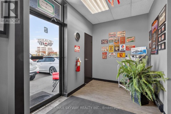 Entrance hall of an auto repair shop with grey walls and vintage signs. - 6 - 181 Rutherford Road, Brampton