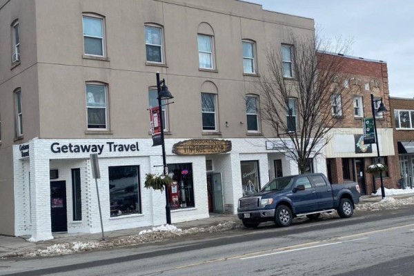 Street view of the building facade with storefronts including 'Getaway Travel' and 'Brooklyn Vintage Decor'. - 6 - 2 Bascom Street S, Uxbridge