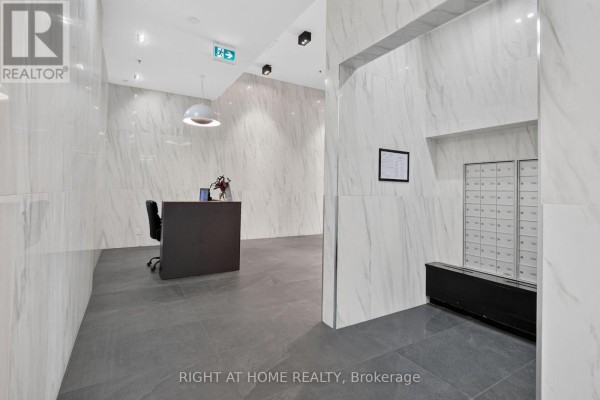 Hallway of apartment building lobby with mailboxes and marble-patterned walls. - 6 - 203 Catherine Street, Ottawa