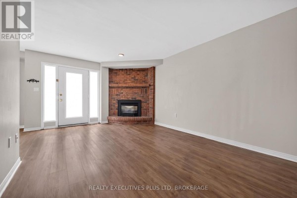 Long interior hallway with grey walls, carpet, and wooden doors. - 6 - 6044 Swayze Drive, Niagara Falls