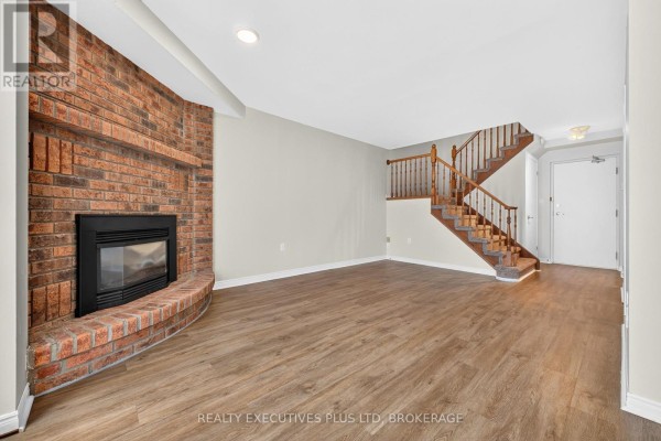 Interior entry hallway with white door, wood-look floor, and adjacent doors. - 6 - 6044 Swayze Drive, Niagara Falls