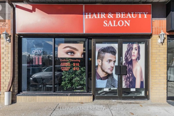 Front view of hair and beauty salon with large windows and promotional posters. - 6 - 665 Plains Road E, Burlington