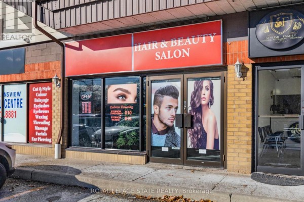 Facade of hair and beauty salon with open sign and promotional posters. - 6 - 665 Plains Road E, Burlington