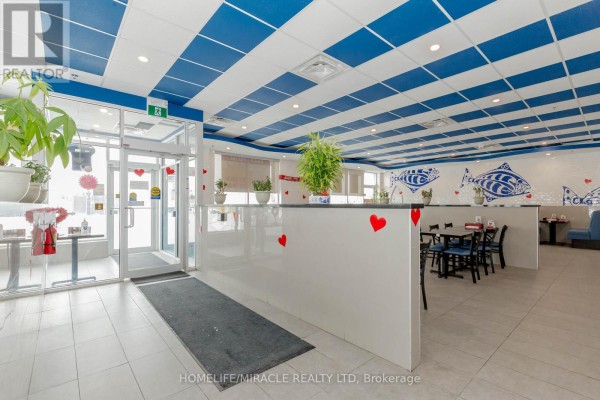 Restaurant dining area with blue and white striped ceiling, booth seating, and tables. - 6 & 7 - 1840 Major Mackenzie Drive, Vaughan