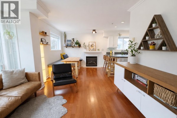 Open living area featuring a leather sofa, dining nook, and built-in shelving. - 6 1233 Main Street, Squamish