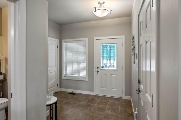 Interior foyer with tiled floor, white door, and a window with blinds. - 6 25 Shorehill Drive, Winnipeg