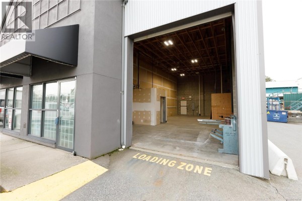 Interior view of warehouse space featuring concrete floors and exposed walls. - 6 2535 Mccullough Rd, Nanaimo