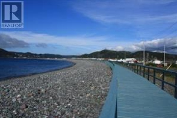 Pebble beach and boardwalk along a body of water with hills in the distance. - 6-8 Tunis Street, Placentia