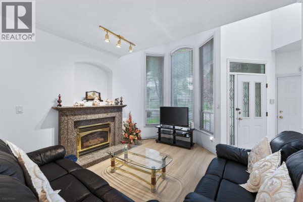 Dining area with a glass-top table, white chairs, and a doorway leading to the living room. - 6 8693 No. 3 Road, Richmond